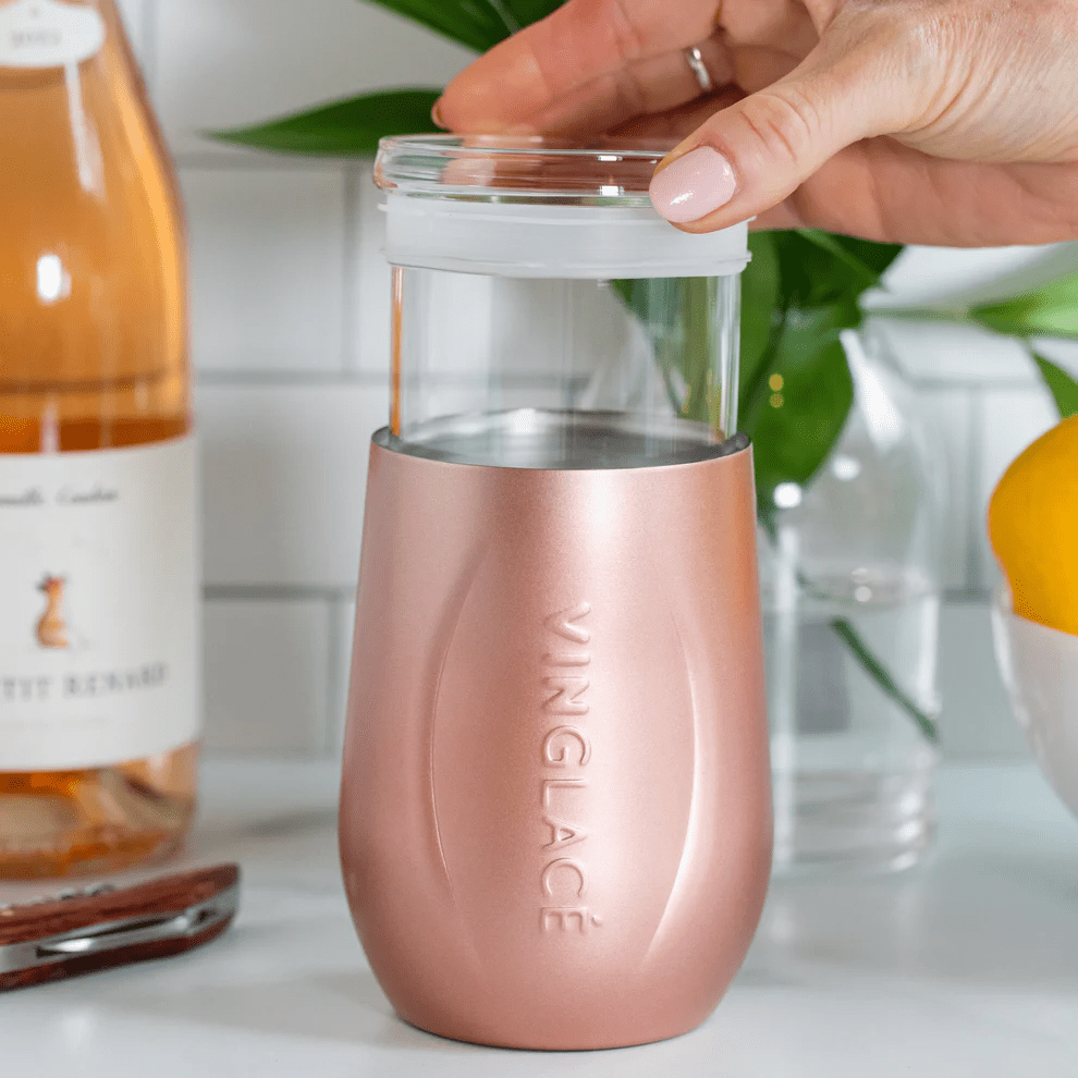 A Wine Tumblers with a Glass inside, on a clean white counter top in a kitchen.